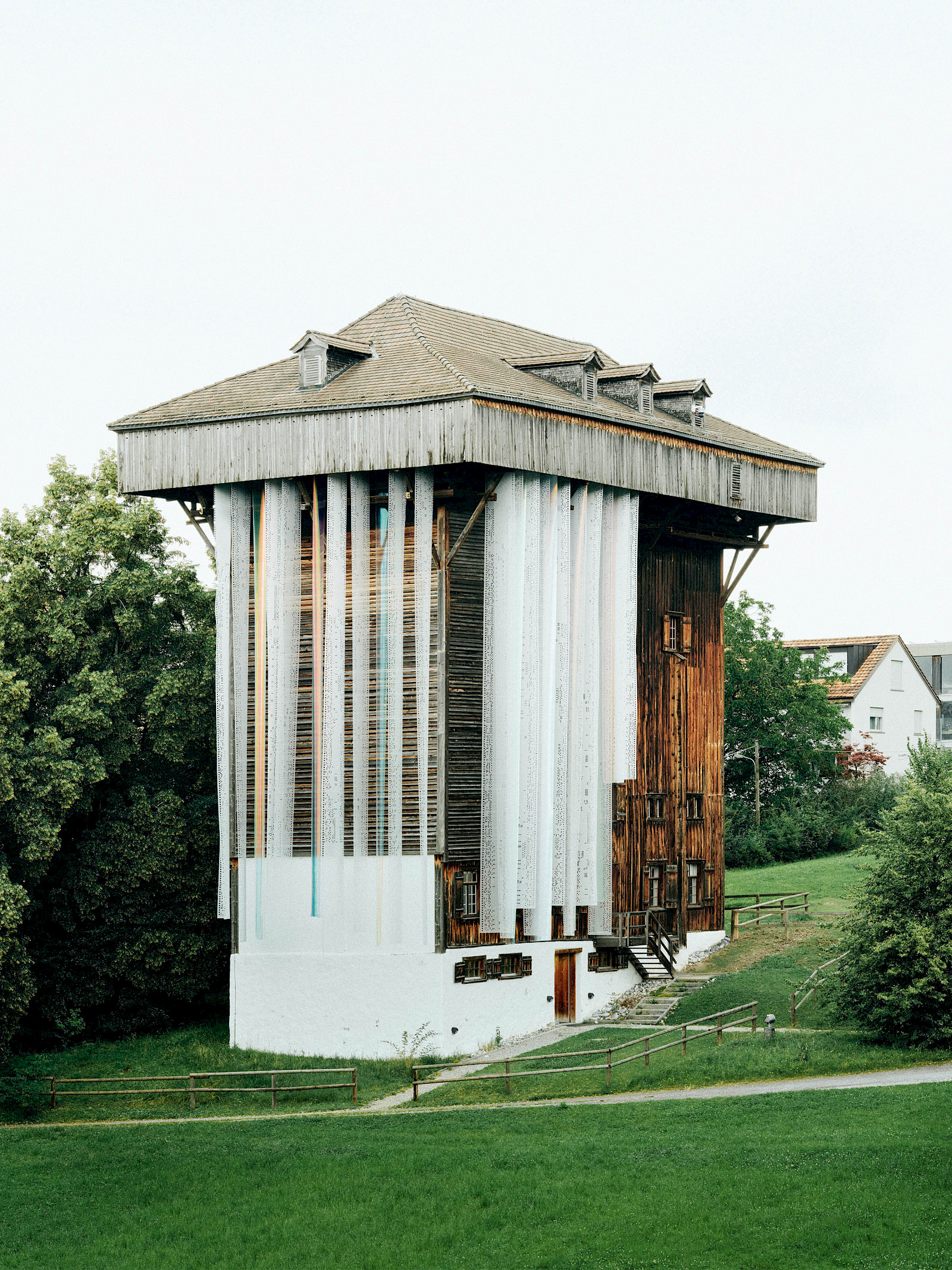 Image - Forget Me Not, 2024, installation at Tröckneturm St. Gallen, laser-cut textile and iridescent foil, Tower: 25 m, Textile panels 15 m